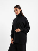 كنزة صوفية بياقة عالية وسحاب